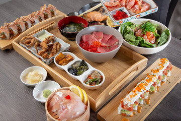 A view of a Japanese restaurant seafood platter, featuring sushi, rolls, nigiri, and deep fried appetizers.