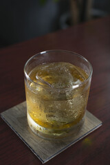 A closeup view of a whiskey on the rocks cocktail.