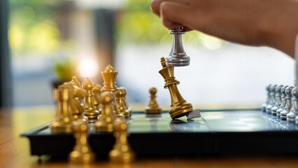 Businessman moving chess pieces on chess board game ideas for ideas and competitions and...