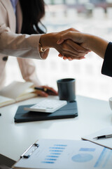 Close-up of business people shaking hands. End of meeting. Business etiquette. congratulations merger concept A businessman accepts or confirms a project as an offer and shakes hands at the office.