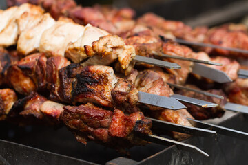 Pile of skewers with fried meat or shish kebab.