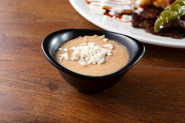 A closeup view of a side of refried beans.