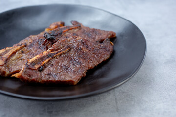 A view of a plate of teriyaki pork short ribs.
