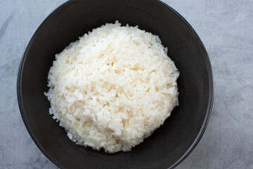 A top down view of a bowl of steamed white rice.