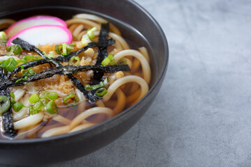 A view of a bowl of udon noodle soup.