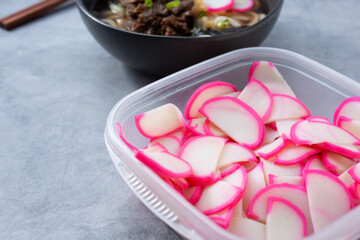 A view of a plastic container of narutomaki.