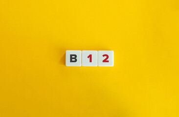 B12 Vitamin. Text on Letter Tiles on Yellow Background. Minimal Aesthetics.
