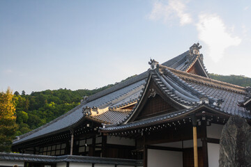 Detail of ancient Japanese traditional roof with clear blue sky background at Tenryu-ji Temple complex in Arashiyama, Kyoto, Japan. No people. 