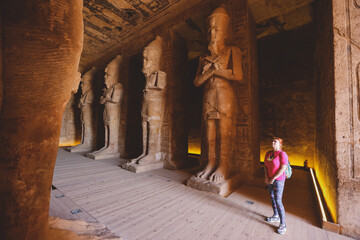 White Woman Tourist looking to the Giant Statues of the Great Temple at Abu Simbel, Egypt