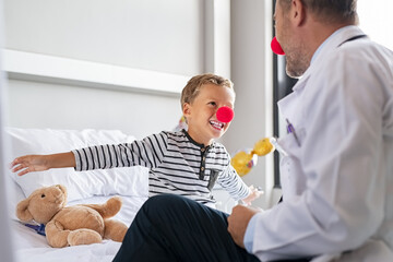 Clown therapy with happy child at hospital