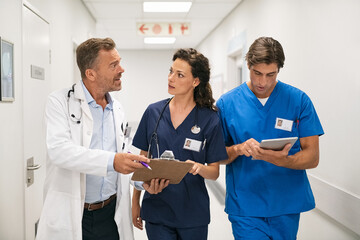 Doctor and nurses discussing patient case at hospital