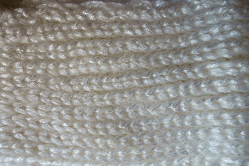 Surface of thick white woolen knitted fabric