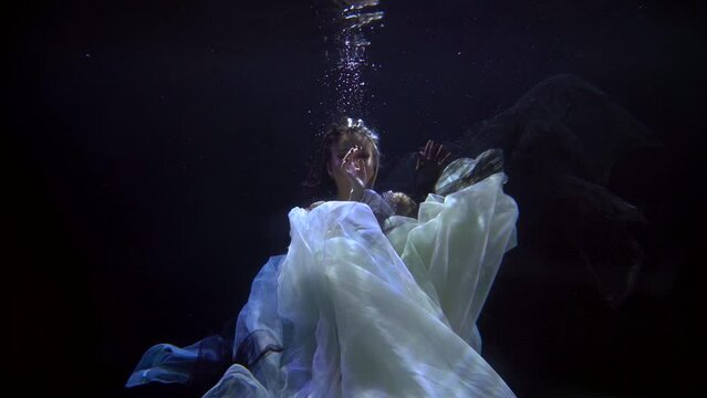 Slow motion picture of a dancing girl under water