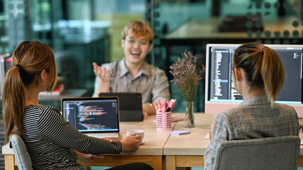 Group of software developers brainstorming and discussion for developing software applications at modern office