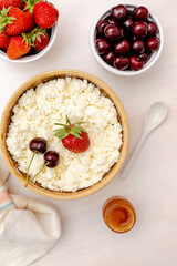 Cottage cheese with summer strawberries cherry berries.curd cheese in bowl with honey.Healthy dairy Calcium,Protein product,food breakfast,lunch,lifestyle,dieting, detox,proper nutrition.Top view