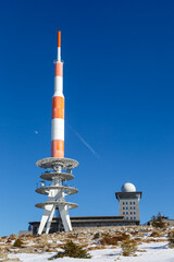 Brocken mountain peak in Harz with snow in winter portrait format in Germany