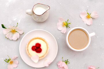 Delicious red raspberry strawberry whipped creamy tartlets,cakes.gourmet confection dessert on plate with latte coffee,milk.sweet tasty pastry baked pie cheesecake with ripe berries on gray table