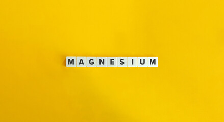 Magnesium Word on Letter Tiles on Yellow Background. Minimal Aesthetics.