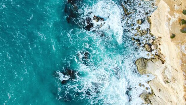 Pure blue ocean water waves crash mountain slow motion in Beautiful Aerial top view landscape in Cyprus