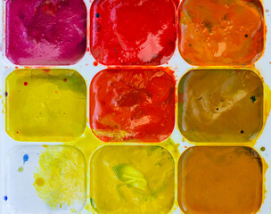 A palette of warm colors in a set of watercolor paints, watercolor paints background