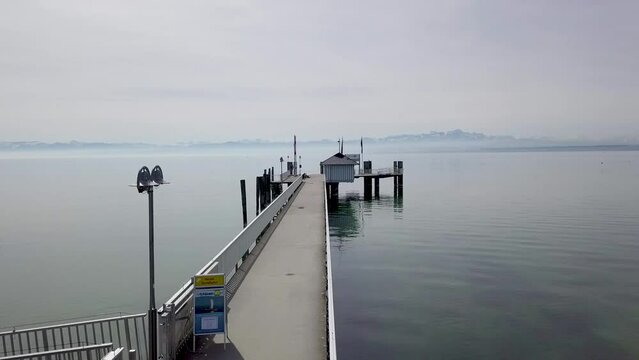 Drone footage of pier with alps in background. Lake of Constance, Immenstaad.