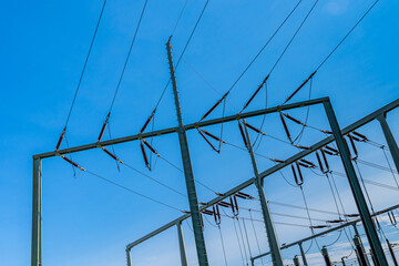 High voltage station wires against the blue sky