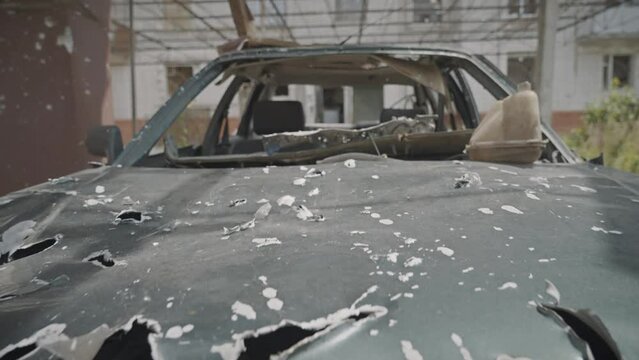 A car riddled with bullets and shrapnel from Russian shells