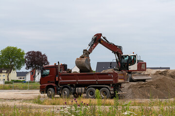 Excavator loading gravel into a truck.