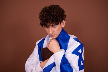 A young handsome guy with an Israeli flag.	