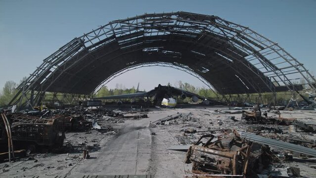 Wrecked Ukrainian world's largest cargo plane stands in a hangar next to a large amount of destroyed Russian equipment