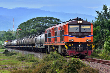 Obraz premium Tanker-freight train by diesel locomotive on the railway in Thailand.