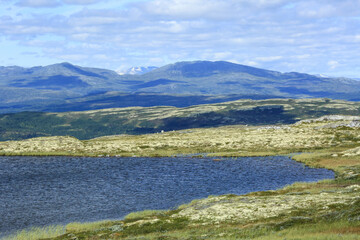 Fototapeta na wymiar Mountains in Innerdalen, Norway, with the lake on the top of the mountain Kletten