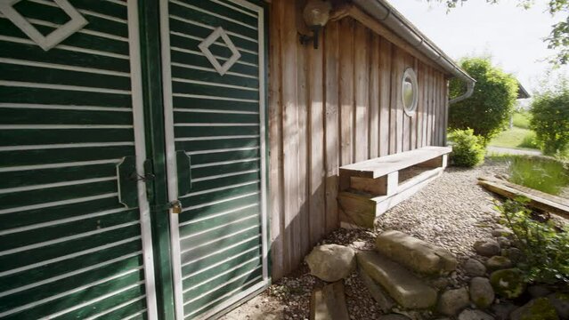 beautiful rural barn with bench and stone garden