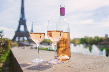 Wine in a glass near the eiffel tower. Selective focus.