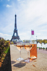 Wine in a glass near the eiffel tower. Selective focus.