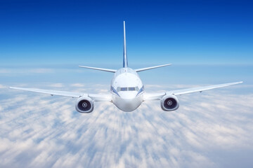 Airplane with motion blur effect is flying over low cloudt. Business travel. Commercial plane.