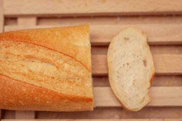 Slicing white bread on a wooden board