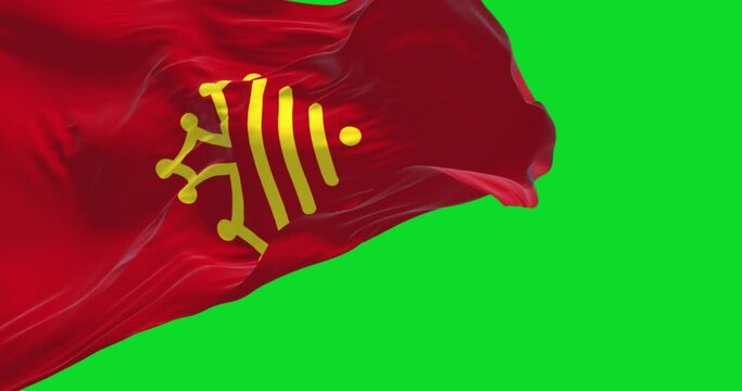 The flag of Occitania region waving in the wind isolated on a green background