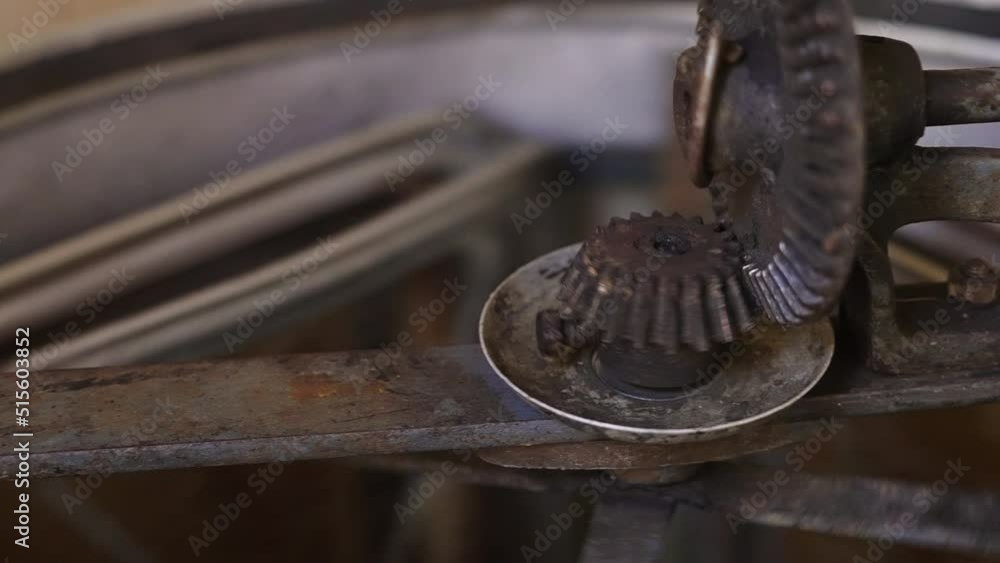 Poster close up of rotating parts of honey extractor machine spinning, honeycomb hive frames turning around