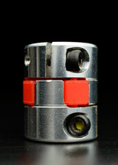 Motor coupling to reduce vibration and smooth start and running of mechanism. Connect to an available spare motor for grinding and polishing work. Selective focus. Dark background.
