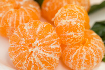 Peeled tangerines on a plate.