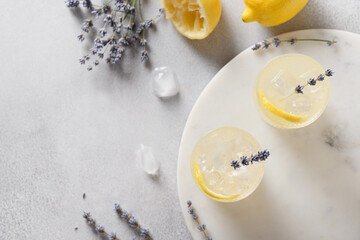 Sparkling summer lavender lemonade in glasses on gray background. View from above. Close up.