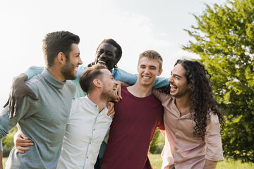 Millenial male friends having fun outside on campus university - Focus on guy face with white shirt