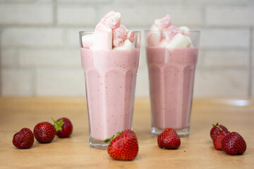 Homemade summer drink strawberry milkshake with strawberries and marmalade copy the mockup space. Concept: homemade summer refreshing drinks 
