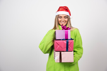 Young smiling woman holding in hands festive Christmas presents