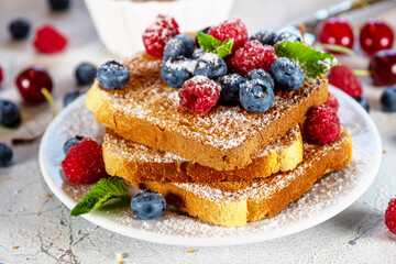 Summer breakfast with french toast. Baked with toasts with berries (blueberries, strawberries) and...