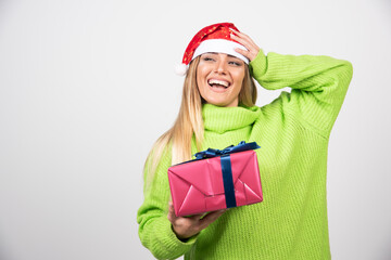 Young woman holding a festive Christmas present