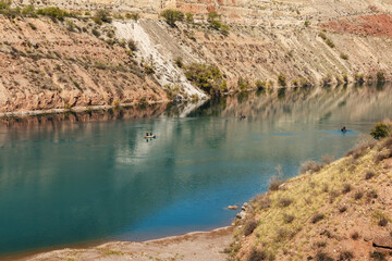 The Naryn River, Kyrgyzstan. Fishermen in boats fishing on the river.