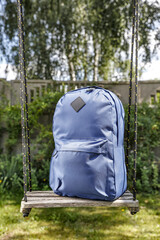 School backpack in grass and free space for your decoration. 