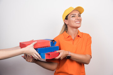 Pizza delivery woman delivering pizza boxes to customer on white background